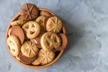 Background with almond and chocolate cookies and on grey vintage table, food concept with copy space, top view