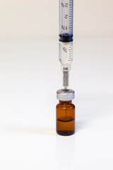 Medical Syringe and a vial of an intravenous drug on a white background
