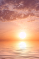 Sunset with storm clouds and water