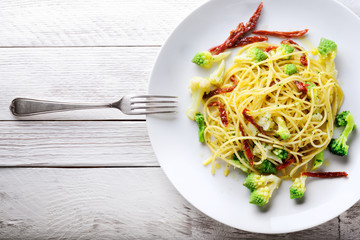 Pasta. Spaghetti with broccoli, cauliflower and dried tomatoes. Space for text