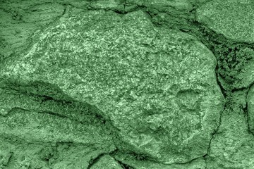 Shaded spruce cobblestone close-up texture, stone surface