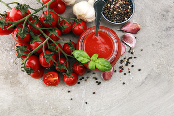 Fototapeta na wymiar Fresh cherry tomato sauce on rustic background with cherry tomatoes.