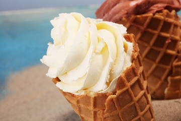 Vanilla frozen yogurt or soft ice cream in waffle cone.