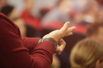 Businesspeople during business conference in conference room or hall