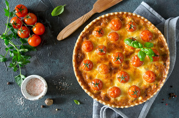Freshly baked homemade pie quiche Lorraine on a concrete background