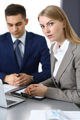 Business people using laptop pc while discussing project in office