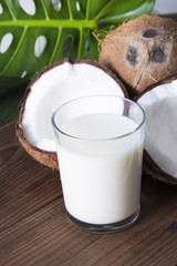 natural coconut on wood with green leaves