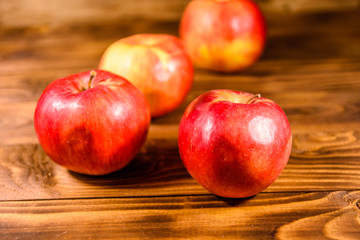Ripe red apples on the wooden table