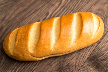 loaf of bread on a brown wooden background