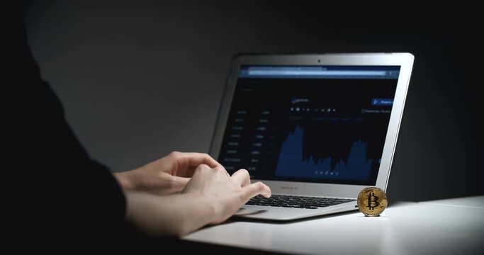 Woman Trading Bitcoin On Notebook Computer in Dark Room