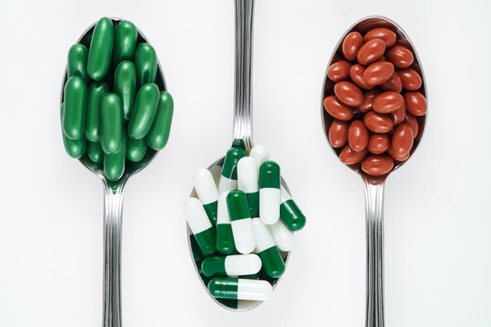 Medicines and food supplements on spoons