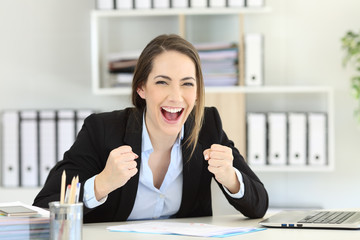 Excited executive looking at camera at office