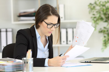 Worried office worker reading sales reports