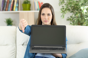 Anwry woman showing a blank laptop screen