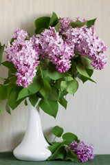 Sprig of Lilac in a vase on the table.