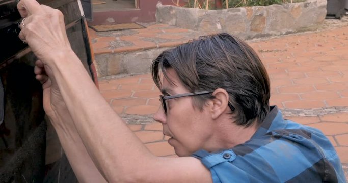 A woman measuring something having trouble seeing with her glasses