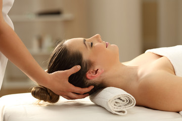 Woman receiving a head massage in a spa