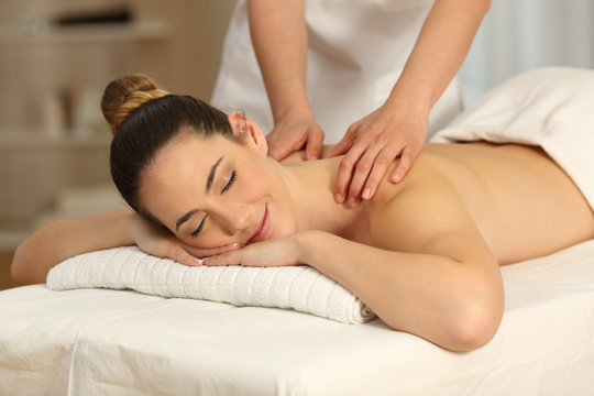 Relaxed woman receiving massage in a salon