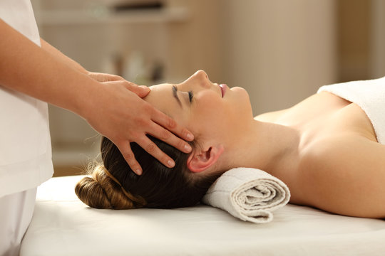 Woman relaxing receiving a facial massage