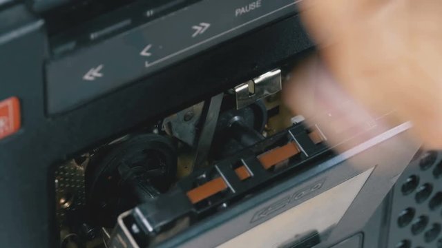 Insert Vintage Audio Cassettes into the Tape Player and Pushing Play, Stop Buttons