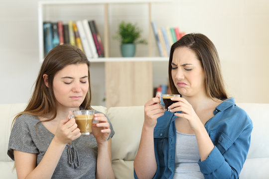 Two friends drinking coffee with bad flavour