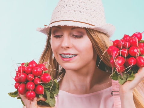 Happy woman giving radish