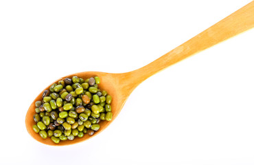 Green beans seeds in wood spoon on white background