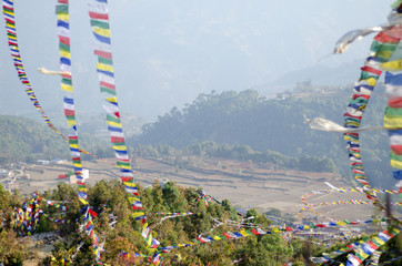 Colorful Buddhist Prayer flags waving on the wind at the hill top