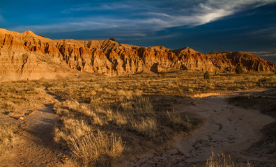 Fototapeta na wymiar Dramatic desert landscape of Cathedral Gorge State Park at sunset in Nevada, USA.
