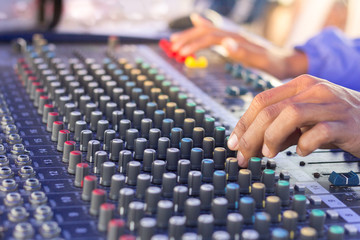 Fototapeta na wymiar hand adjusting volume sound of mixer, sound and music concept