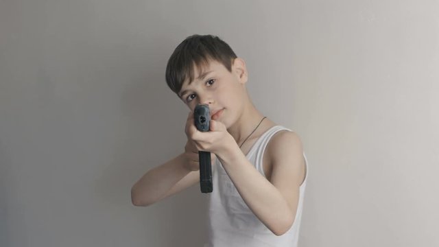 Portrait of Boy plays with the toy gun