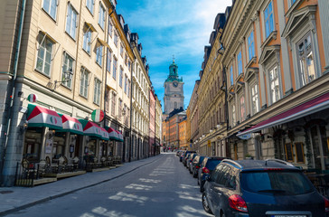 Church clocktower at the end of a European street