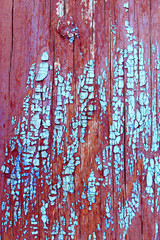 Old wooden background with remains of pieces of scraps of old paint on wood. Texture of an old tree, board with paint, vintage background peeling paint. old blue board with cracked paint, vintage