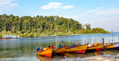 Wooden boats lined up for tourists at Jolly Buoy island Andaman India.