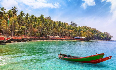 Fototapeta na wymiar Scenic Ross Island beach at Andaman India with view of a wooden boat.