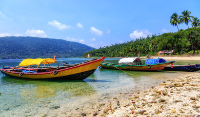Fototapeta na wymiar Wooden boats lined up at North Bay island beach Andaman India with scenic landscape view.