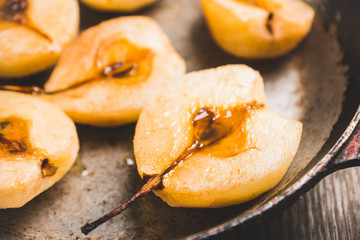 Grilled pears with cinnamon and honey on the rustic background. Selective focus.