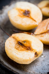 Grilled pears with cinnamon and honey on the rustic background. Selective focus.