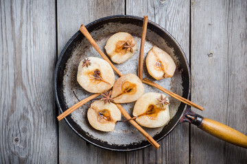 Grilled pears with cinnamon and honey on the rustic background. Selective focus.