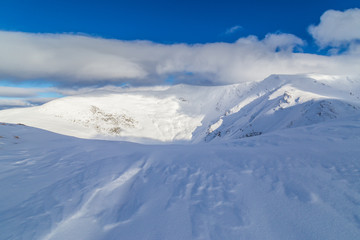 Beautiful  winter scenery in the mountains, with fresh snow, and mist, on a bright sunny day
