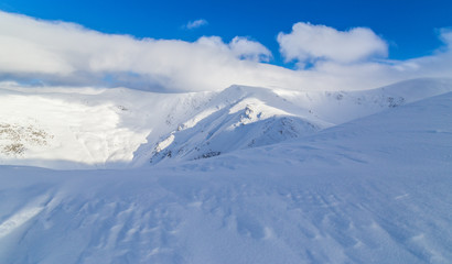 Beautiful  winter scenery in the mountains, with fresh snow, and mist, on a bright sunny day