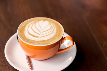 latte art coffee on wooden table