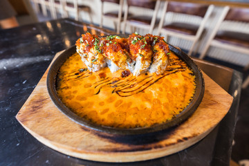 Fusion Sushi on hot pan name Demon roll,Tradition of Japanese food