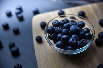 fresh ripe blueberries in glass bowl close up