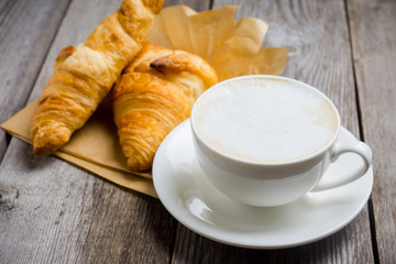 Breakfast with coffee, croissants and grilled pears with honey. Selective focus.