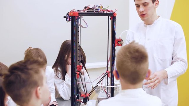 Children at school are studying a 3d printer