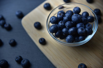 fresh ripe blueberries in glass bowl close up