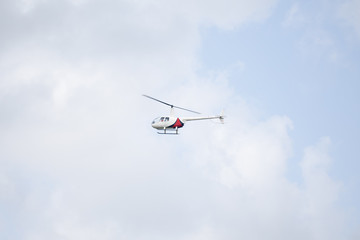 Fototapeta na wymiar Helicopter flying in a sky