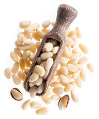 Pine nuts in the wooden scoop. White background.