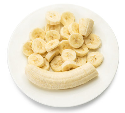 Peeled banana and banana slices on the plate.